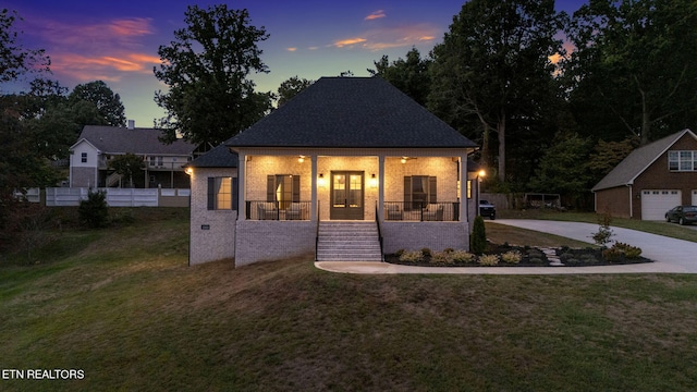 view of front of house with a porch and a lawn