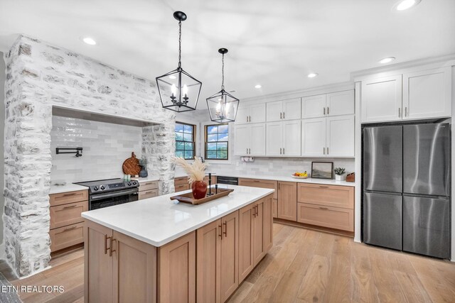 kitchen with a center island, white cabinets, stainless steel refrigerator, light hardwood / wood-style flooring, and black electric range oven