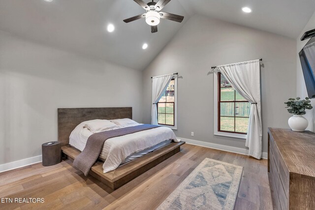 bedroom featuring high vaulted ceiling, light wood-type flooring, and ceiling fan