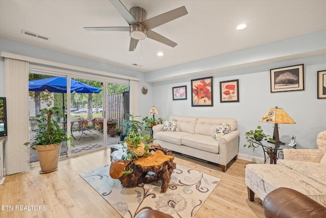 living room with ceiling fan and light hardwood / wood-style flooring