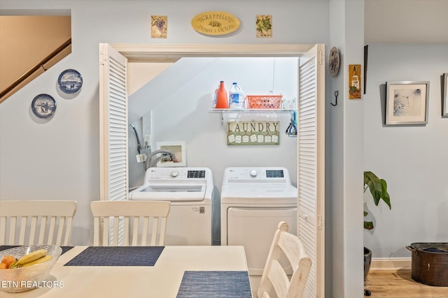 laundry room featuring light wood-type flooring and washer and clothes dryer