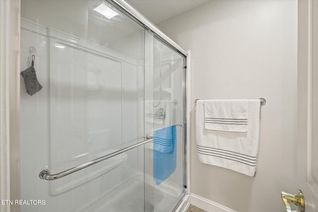 bathroom with a shower with shower door