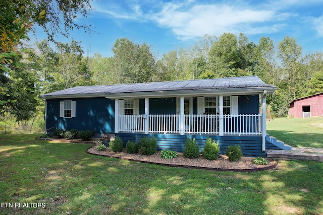 single story home featuring a front lawn and covered porch