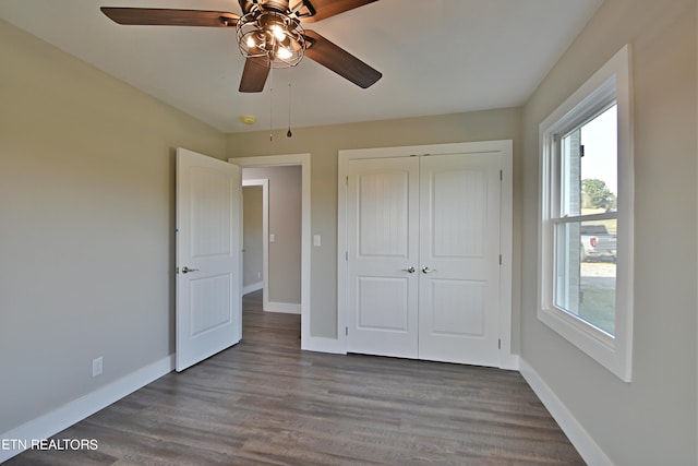 unfurnished bedroom with a closet, ceiling fan, and dark hardwood / wood-style floors