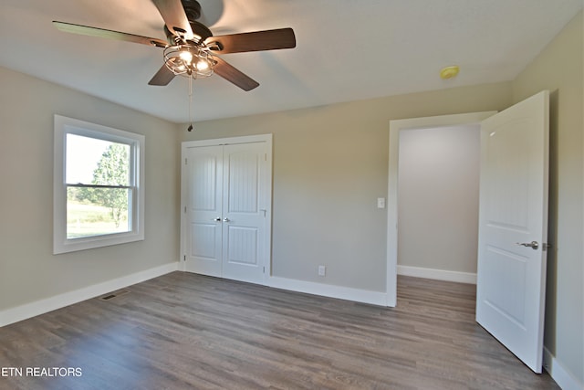 unfurnished bedroom featuring ceiling fan, a closet, and light hardwood / wood-style flooring