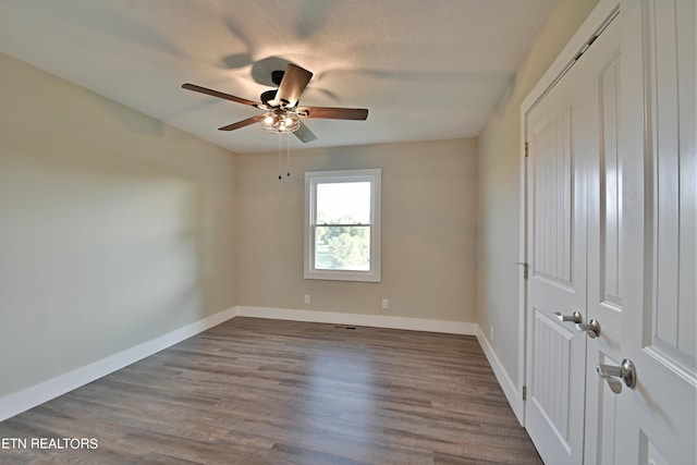 unfurnished bedroom featuring ceiling fan and hardwood / wood-style flooring