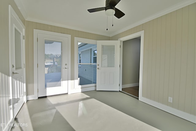 interior space with ceiling fan and crown molding