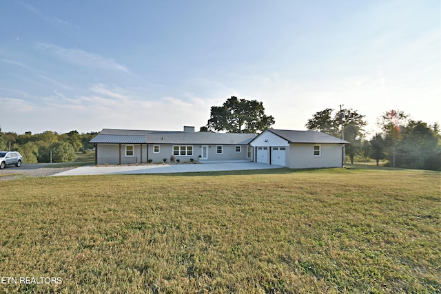 ranch-style house featuring a front yard and a garage