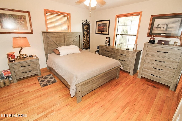 bedroom with light hardwood / wood-style flooring and ceiling fan