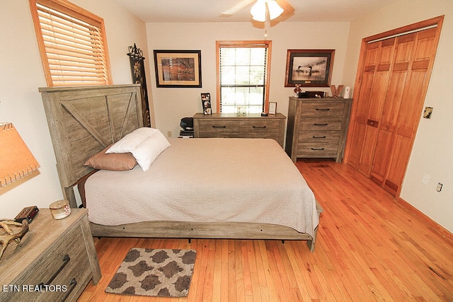 bedroom featuring light hardwood / wood-style flooring, a closet, and ceiling fan