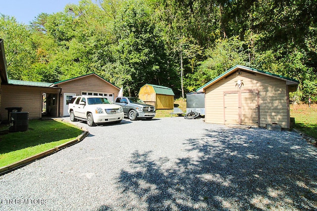 garage with a lawn and central AC