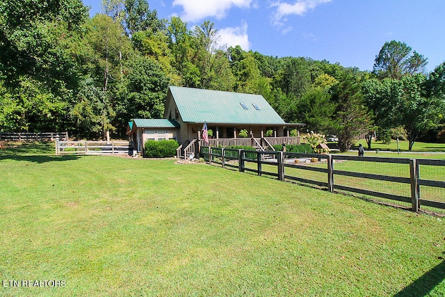 view of yard with an outdoor structure and a rural view