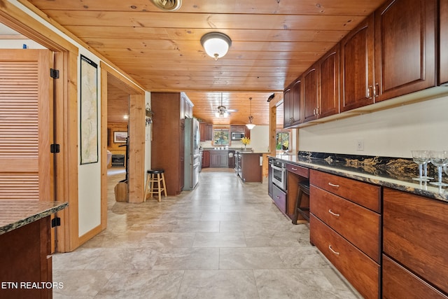 kitchen with dark stone countertops, wood ceiling, decorative light fixtures, and appliances with stainless steel finishes