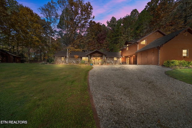 view of front facade with a garage and a yard