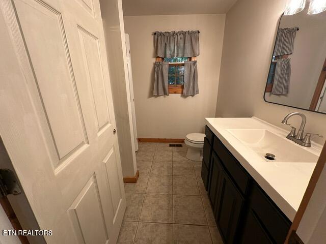 bathroom featuring vanity, toilet, and tile patterned floors