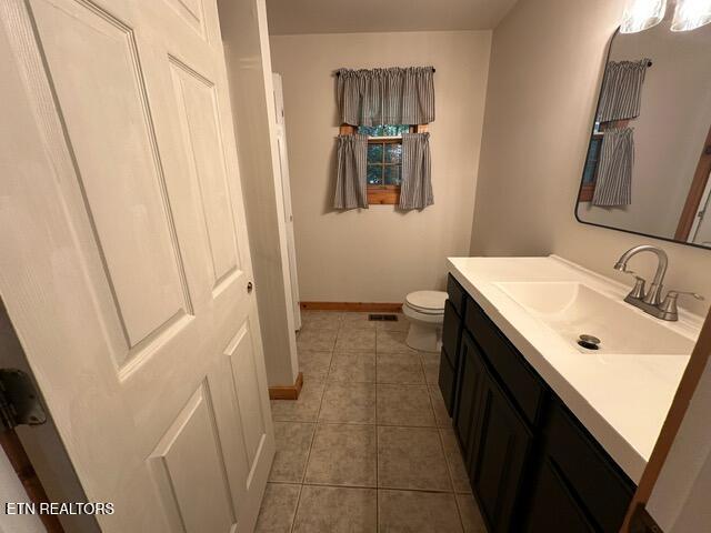 230 Penni Ln, Townsend, TN 37882 - bathroom featuring vanity, tile patterned floors, toilet, and baseboards