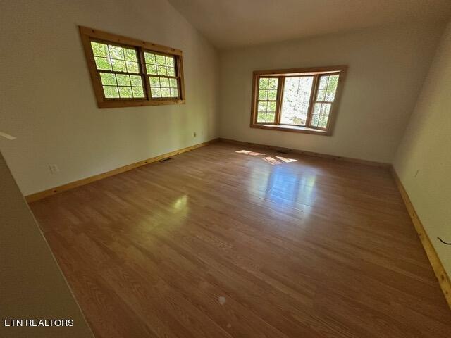 230 Penni Ln, Townsend, TN 37882 - unfurnished room with wood finished floors, vaulted ceiling, and baseboards