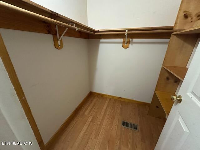 spacious closet featuring light hardwood / wood-style flooring