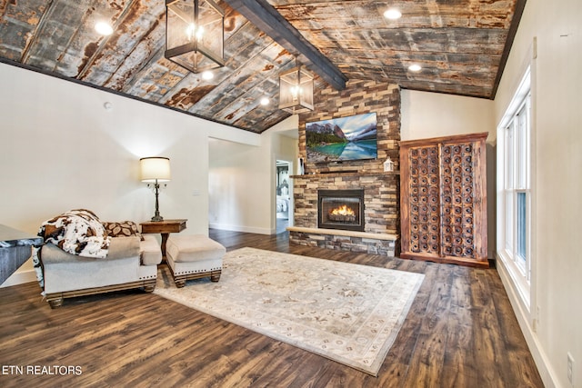 living room with lofted ceiling with beams, wood-type flooring, and a fireplace