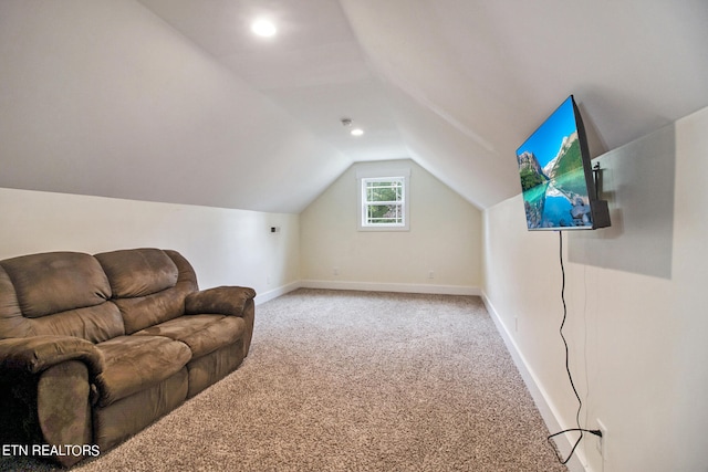 additional living space with carpet flooring and vaulted ceiling