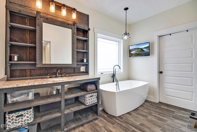 bathroom with vanity and a bath