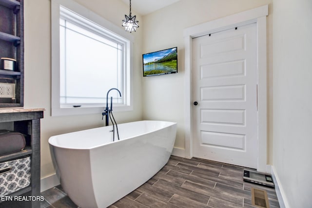 bathroom with vanity, hardwood / wood-style flooring, and a tub