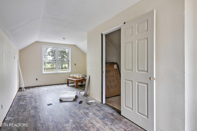 additional living space featuring hardwood / wood-style flooring and vaulted ceiling