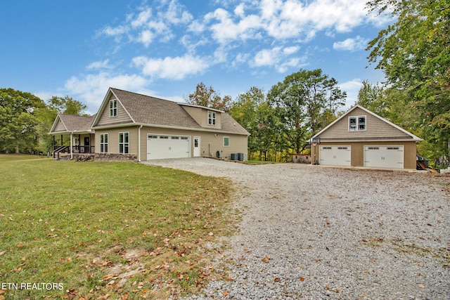 view of front facade with a garage, a front lawn, central AC unit, and covered porch