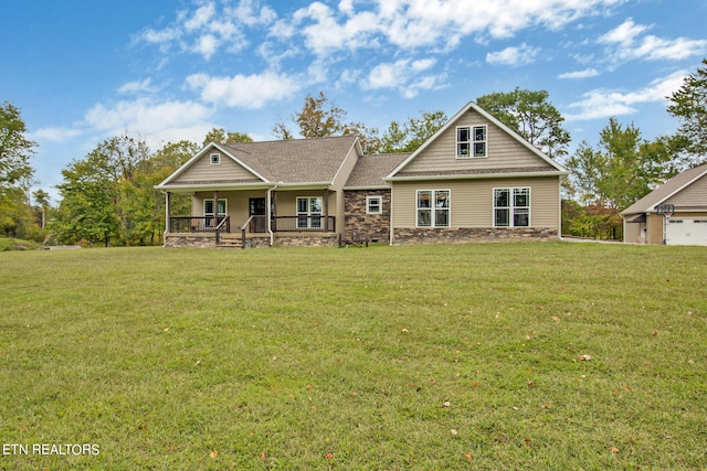 craftsman-style home featuring a garage, a front yard, and covered porch