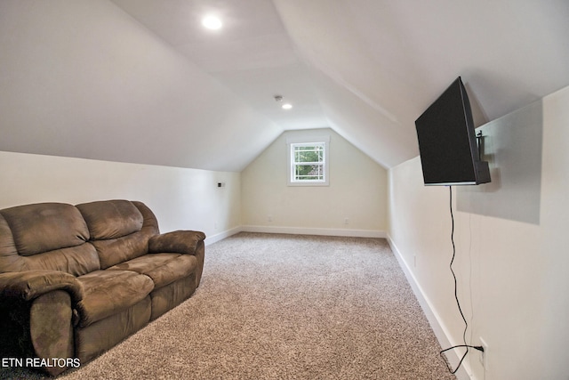 additional living space with vaulted ceiling and carpet