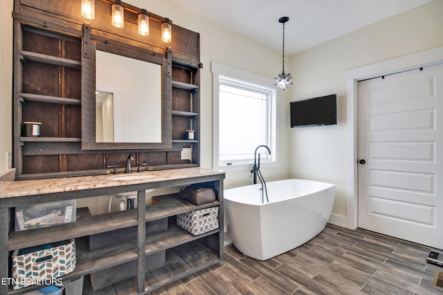 bathroom featuring vanity and a washtub