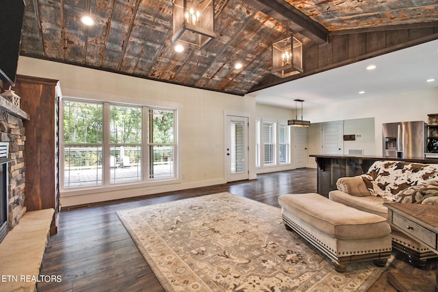 living room with high vaulted ceiling, beamed ceiling, dark hardwood / wood-style floors, and a fireplace