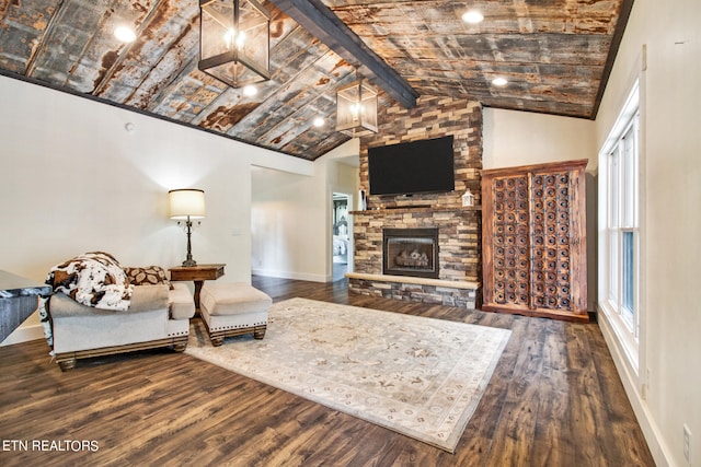 living room with wood-type flooring, a fireplace, and lofted ceiling with beams