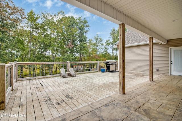 wooden deck featuring a grill