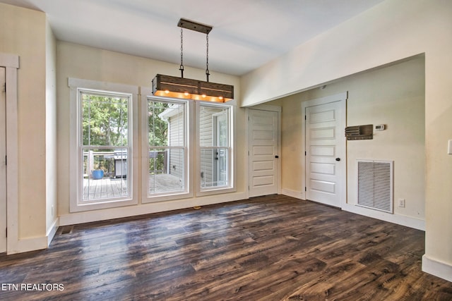 unfurnished dining area featuring dark hardwood / wood-style flooring