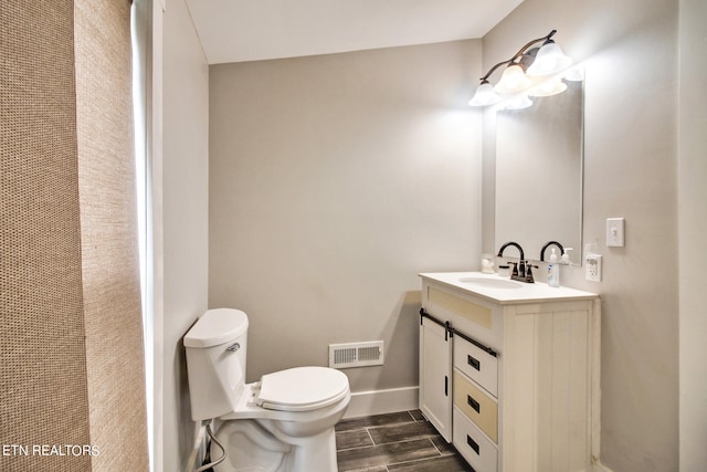 bathroom featuring hardwood / wood-style floors, vanity, and toilet