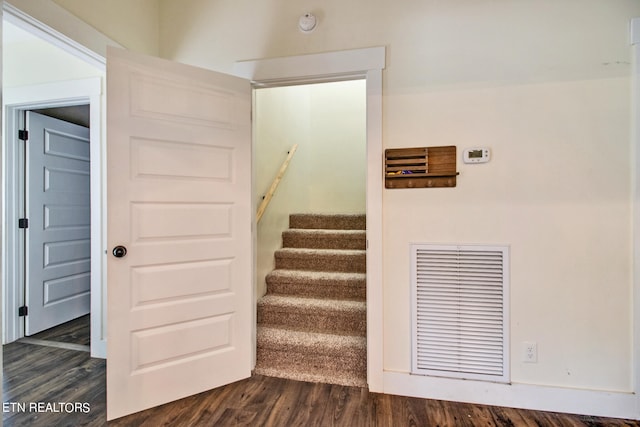 stairs with hardwood / wood-style flooring