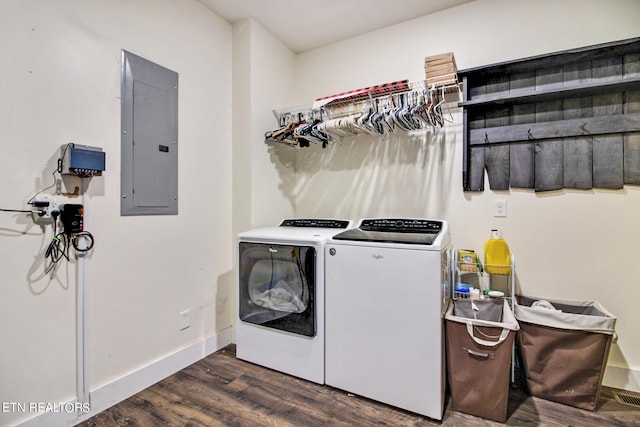 laundry room with dark hardwood / wood-style floors, electric panel, and washer and dryer