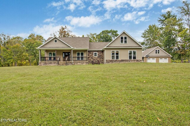 craftsman-style house with an outbuilding, a front lawn, a garage, and covered porch