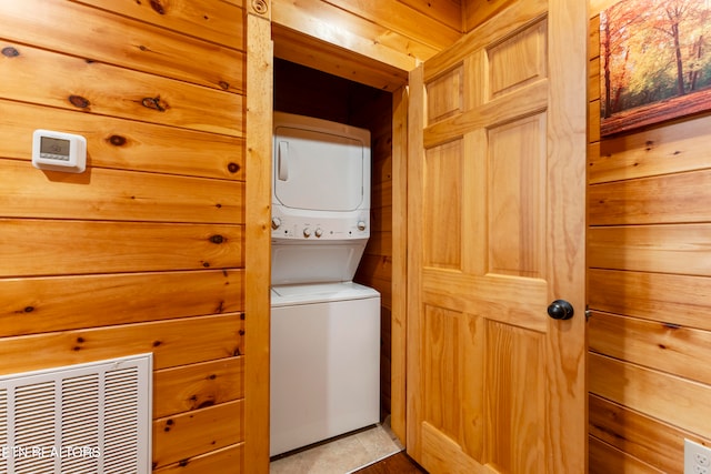 889 Great Smoky Way, Gatlinburg, TN 37738 - clothes washing area with wood walls, tile patterned floors, and stacked washer and dryer
