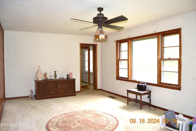 sitting room with light carpet and ceiling fan