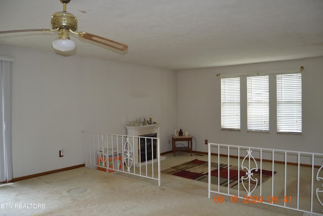 unfurnished bedroom featuring ceiling fan and carpet flooring