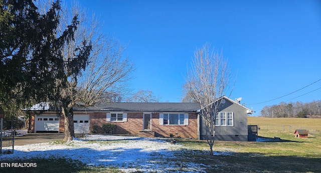 single story home featuring a front yard and a garage