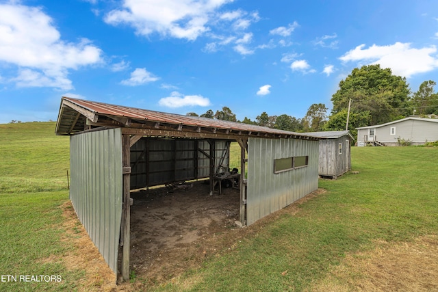 view of outbuilding featuring a yard