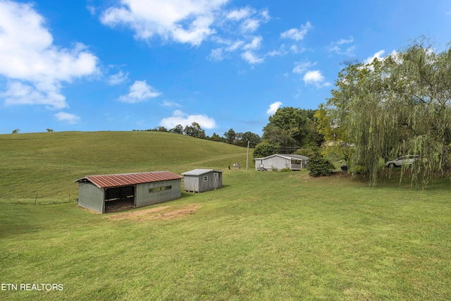 view of yard with a rural view and an outbuilding