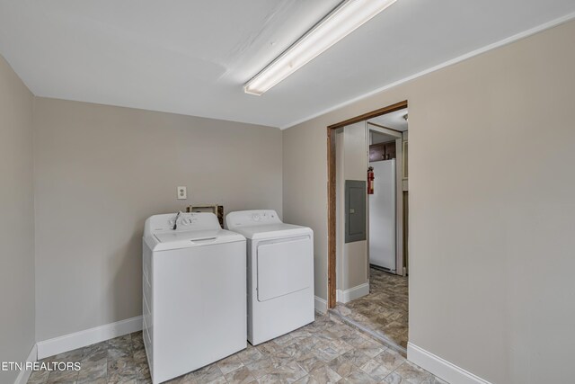 laundry room with electric panel and separate washer and dryer