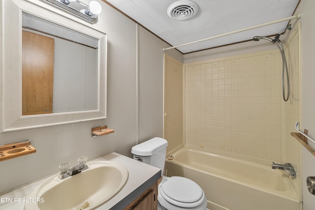 full bathroom with tiled shower / bath, vanity, and toilet