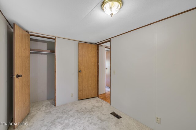 unfurnished bedroom featuring light colored carpet