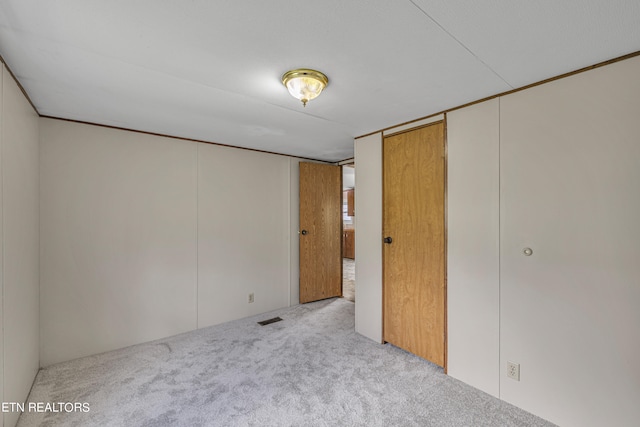 unfurnished bedroom with light carpet