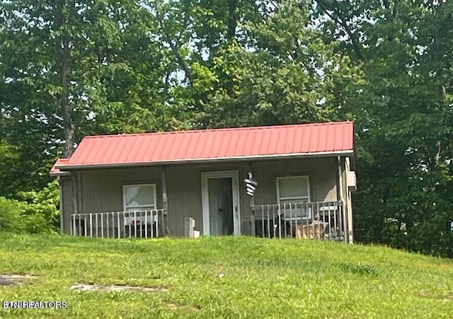 exterior space with a porch and a yard